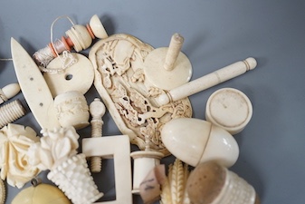 A mixed collection of antique ivory to include a late 18th / early 19th century Chinese carved cartouche, a simulated jockey cap tape measure, etc